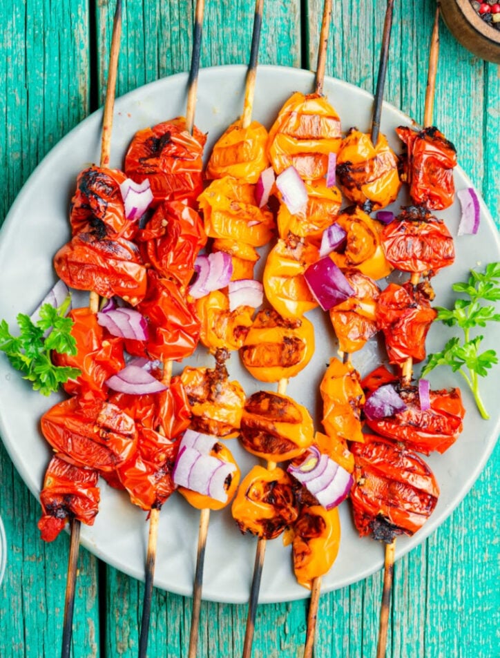 how to cut tomatoes for kabobs on blue background