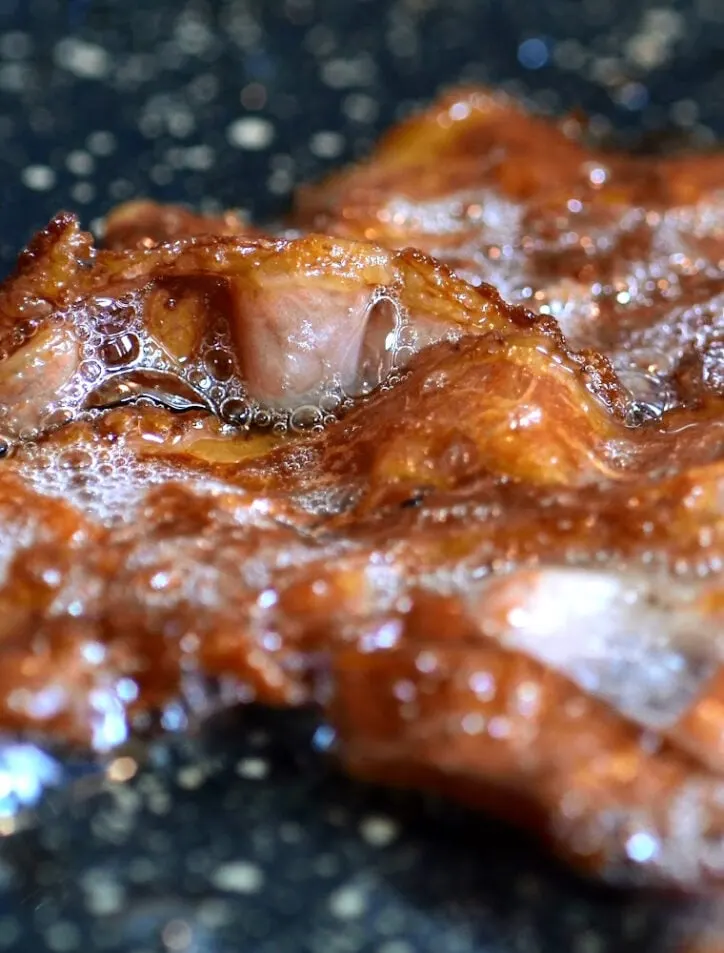 toaster oven bacon cooking in the pan
