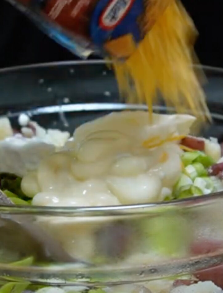 adding ingredients to steakhouse potato salad