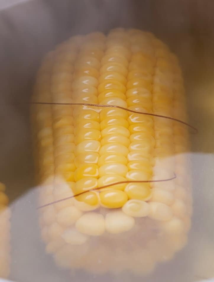 frozen corn on the cob cooking in water