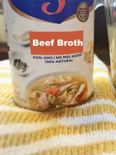 can of canned beef broth on towel