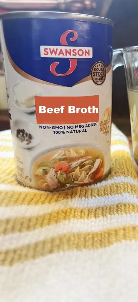 can of canned beef broth on towel.
