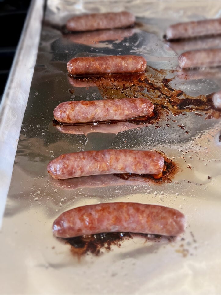 Breakfast sausage links on aluminum foil.