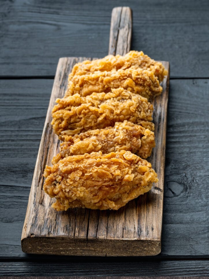 Fried chicken on cutting board. 