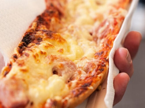 hand holding french bread pizza.