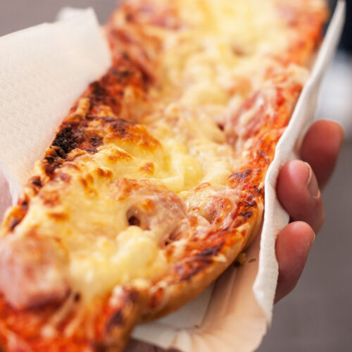 hand holding french bread pizza.