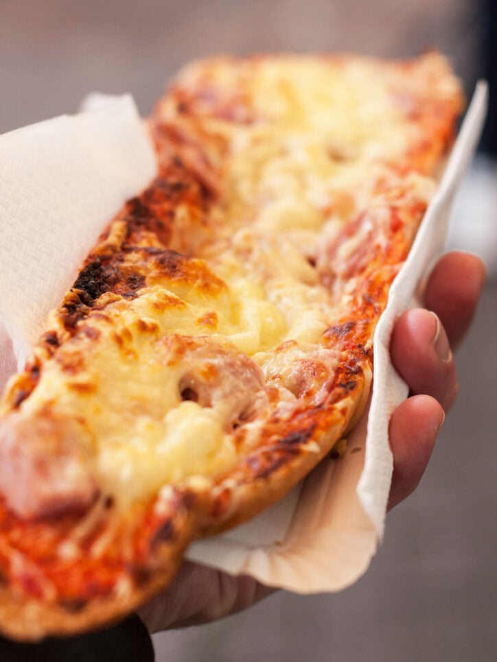 hand holding french bread pizza.