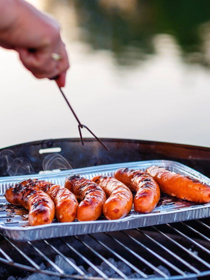 Smoked sausage on grill in pan.