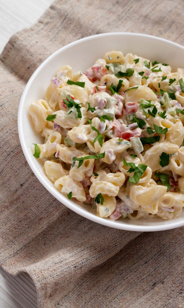 The Best Bacon Ranch Pasta Salad Recipe - Creamy on a brown towel.