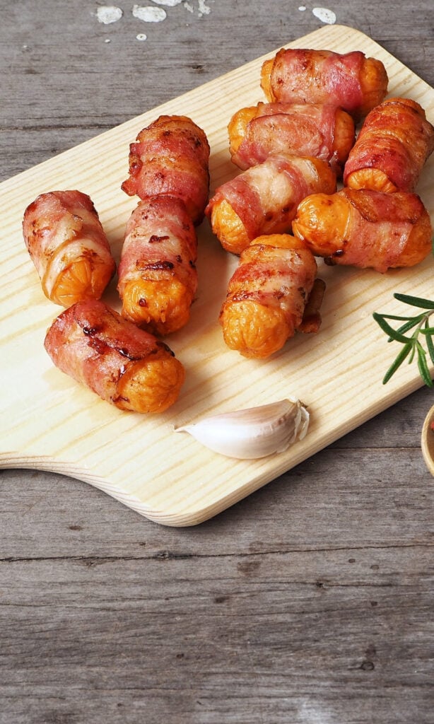 Maple Bacon Wrapped Andouille Bites Recipe on cutting board. 