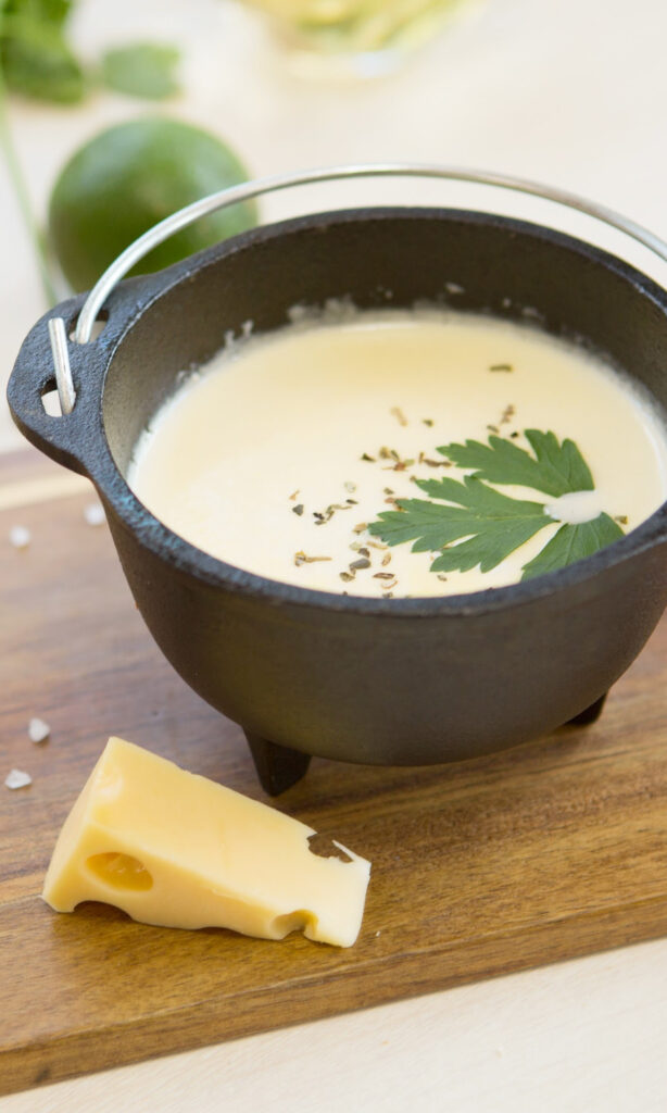 potato cheese soup in a small black bowl.