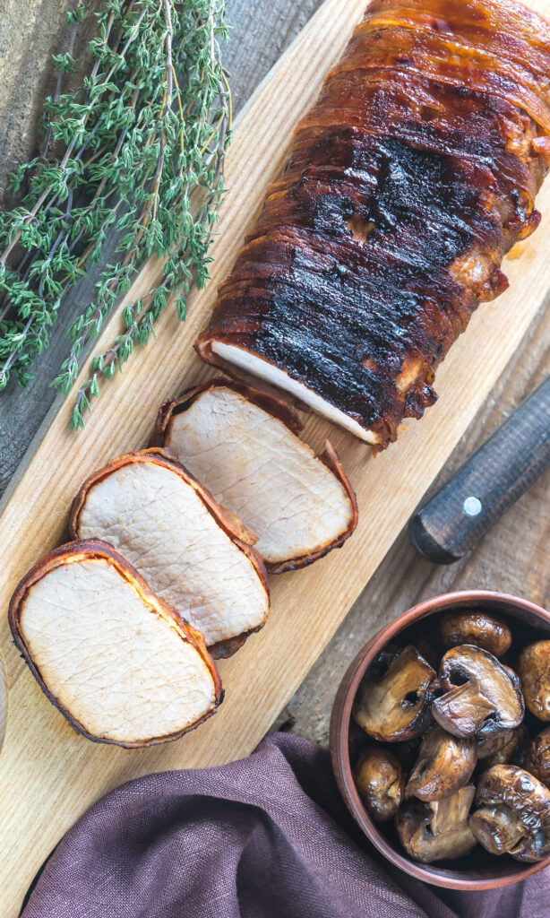 slices of bacon wrapped pork loin.