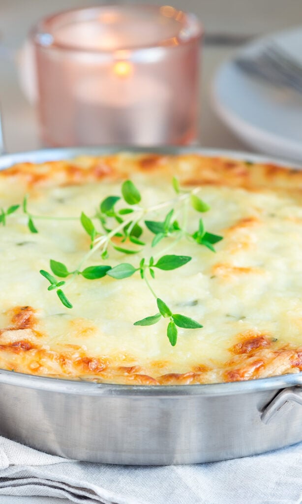 Cheesy Ham and Tomato Pasta with spring of herbs.