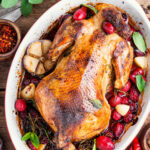 whole chicken in a crockpot with herbs.