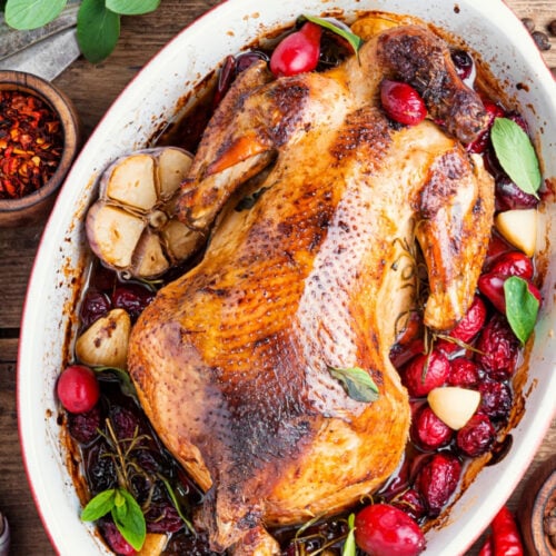 whole chicken in a crockpot with herbs.