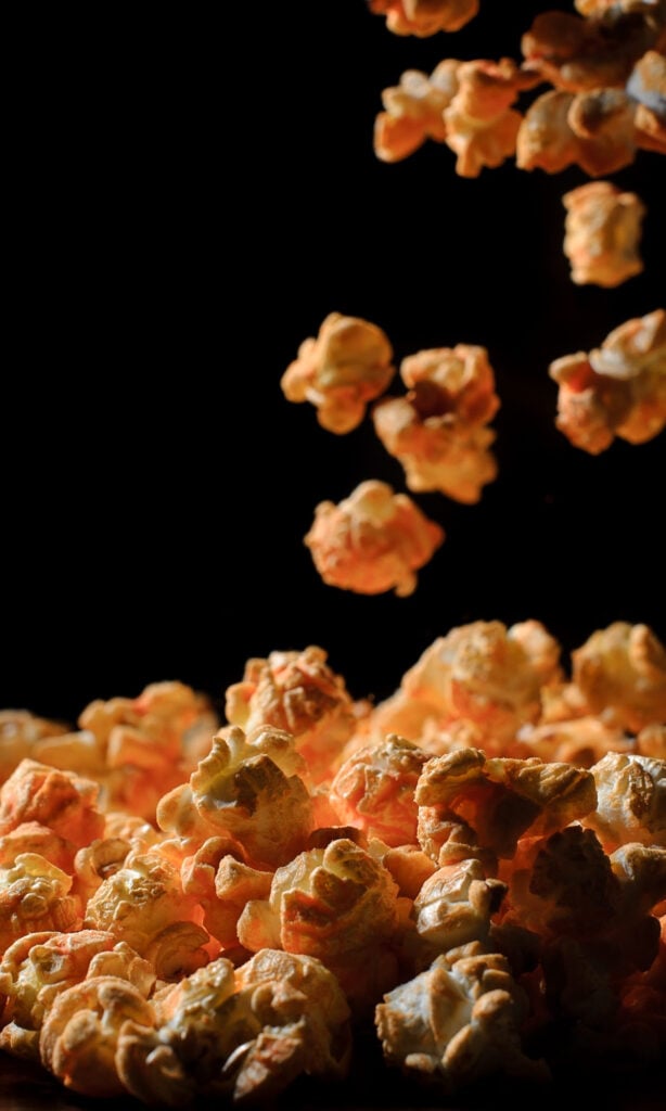 Best Hot Wing Popcorn Recipe on black background.