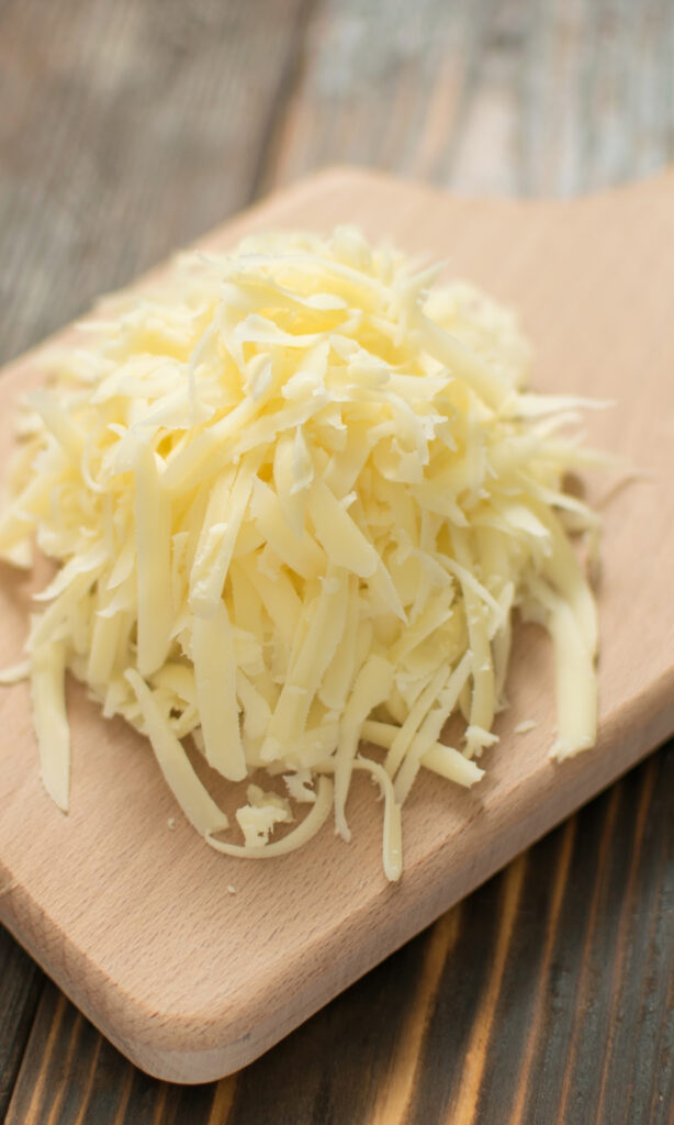 Grated Cheese on cutting board.