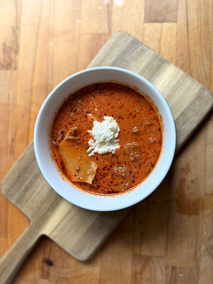 bowl of lasagna soup on a cutting board
