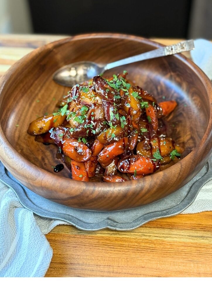 Honey Mustard Glazed Carrots, in a bowl with a spoon in the bowl