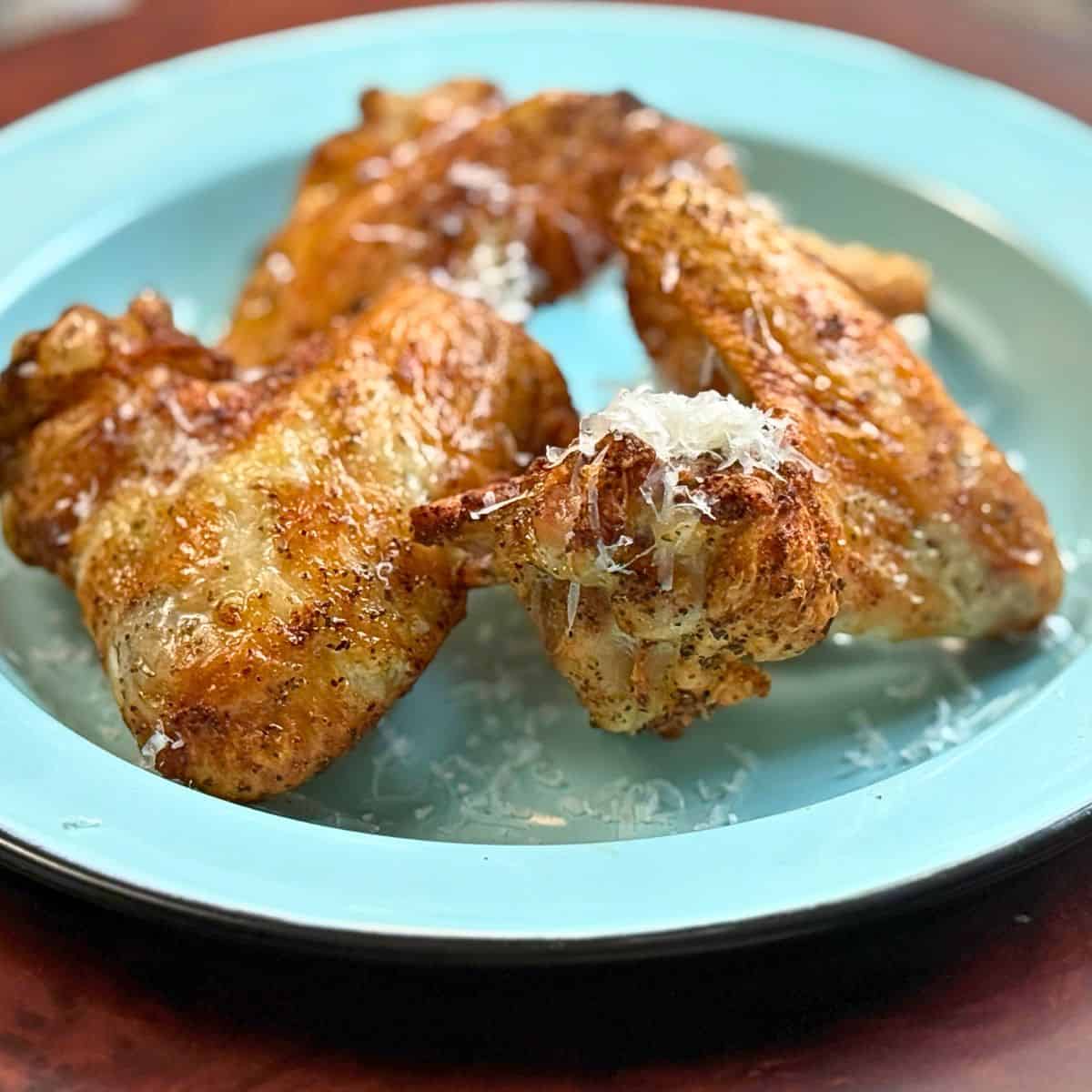 Golden brown, and crispy chicken wings on a plate