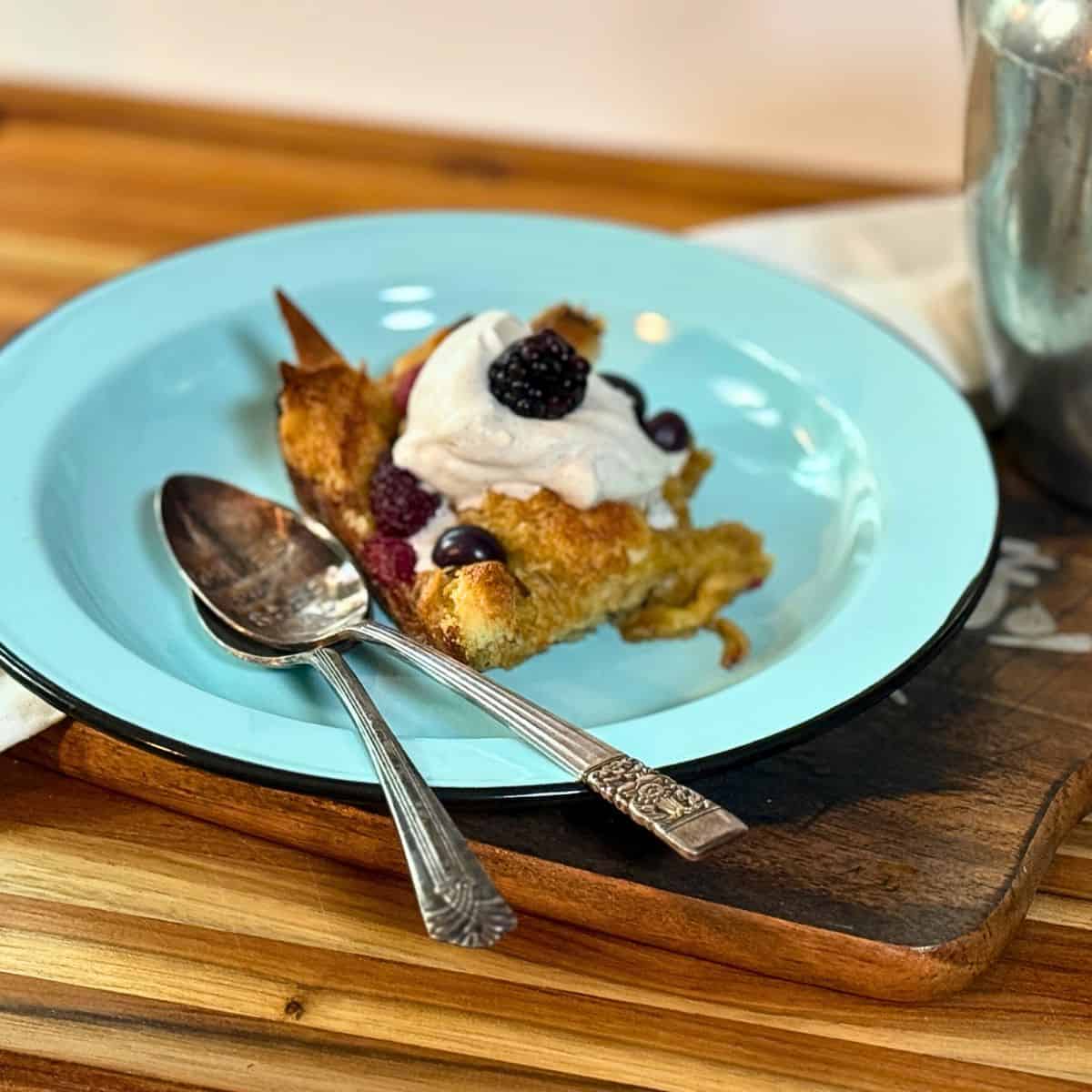 french toast slice on a blue plate with a spoon