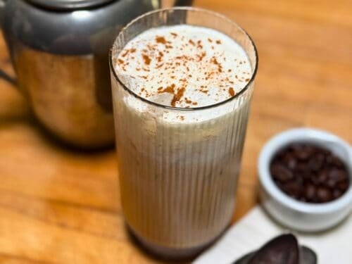 A glass with coffee and cold foam on top