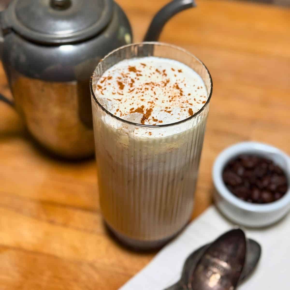 A glass with coffee and cold foam on top