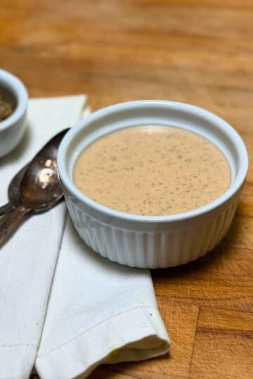 Greek Dressing with spoons in a white dish