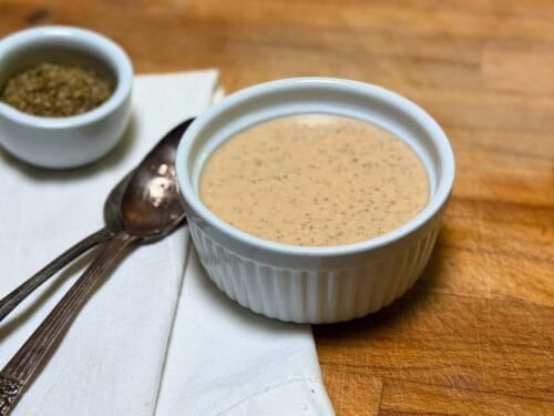 Greek Dressing with spoons in a white dish