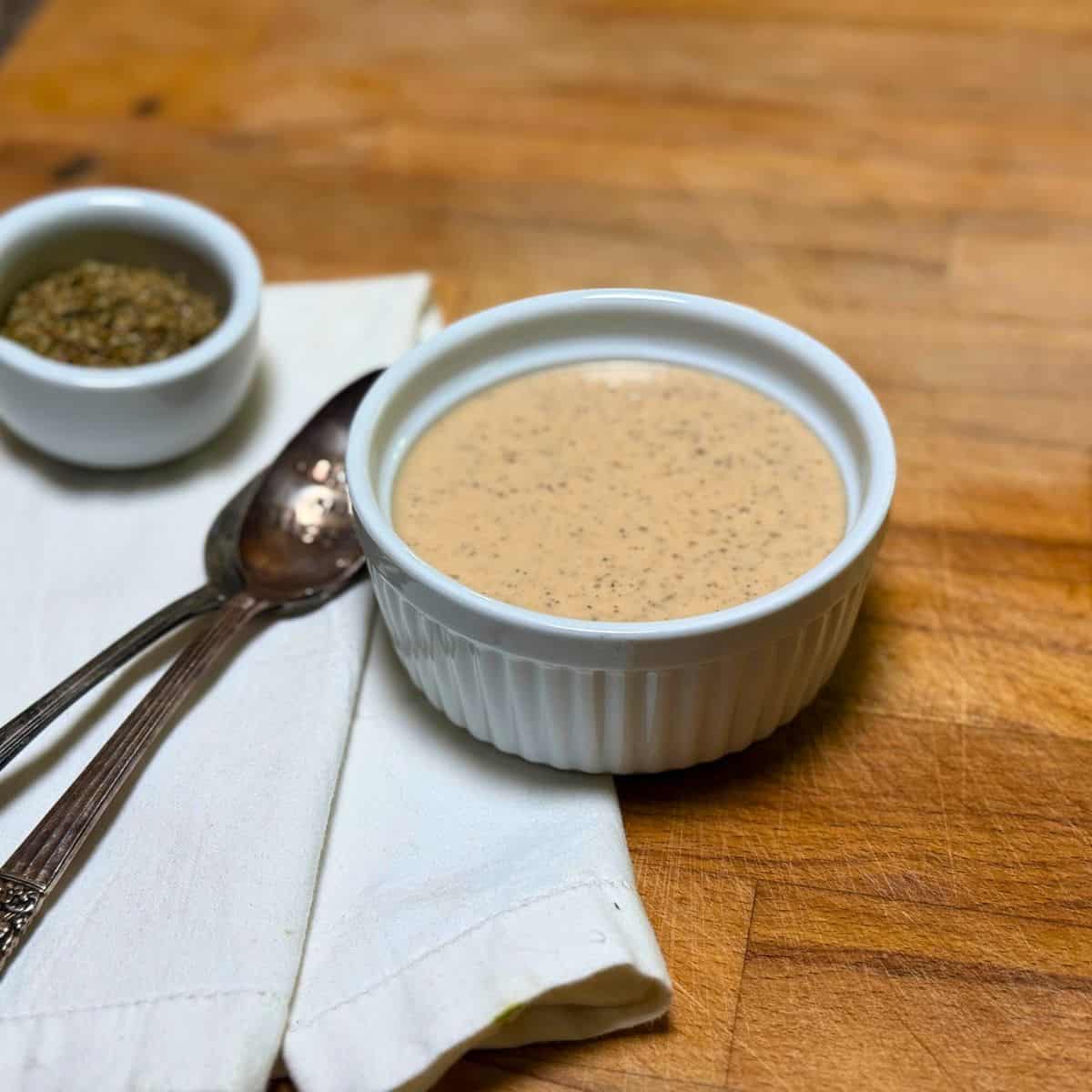 Greek Dressing with spoons in a white dish