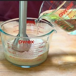 slowly adding oil to the dressing the emulsify